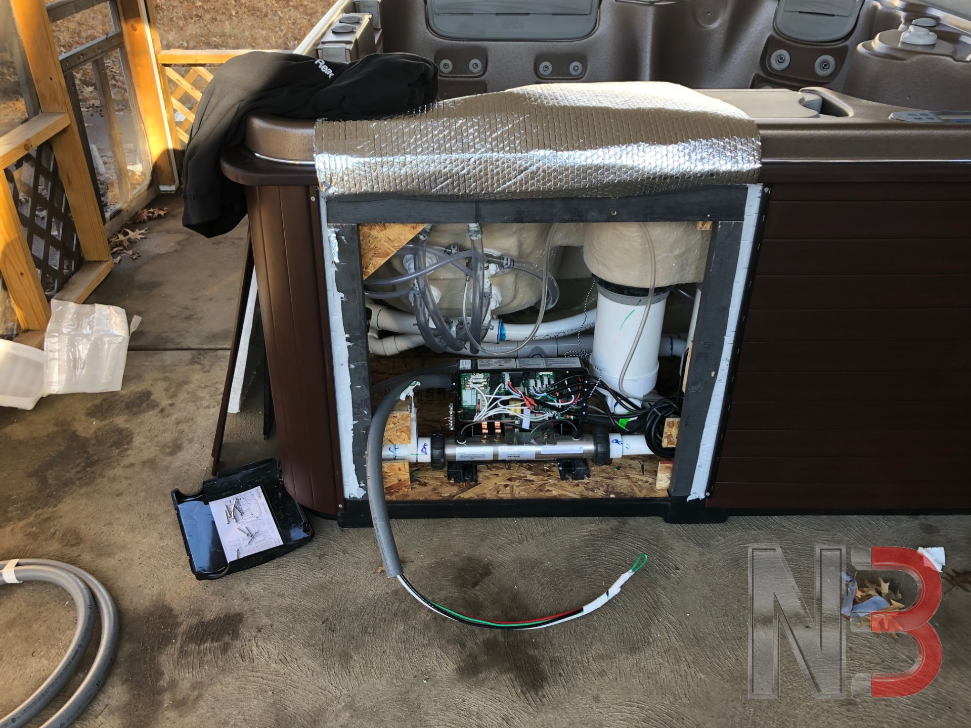 Hot tub equipment bay with new wiring run to the spa control pack