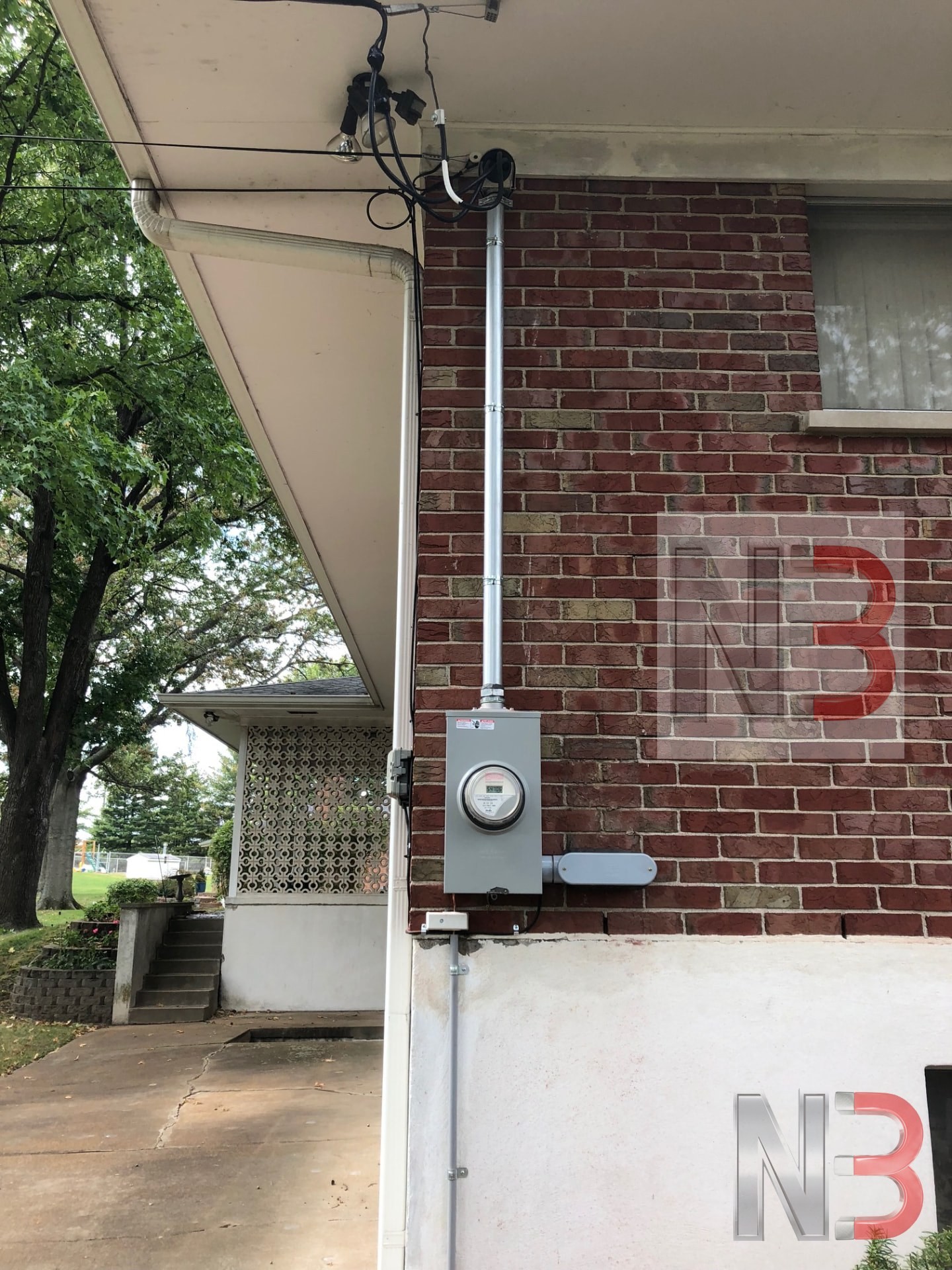 New meter socket, riser and weatherhead installed on a brick home after a service change