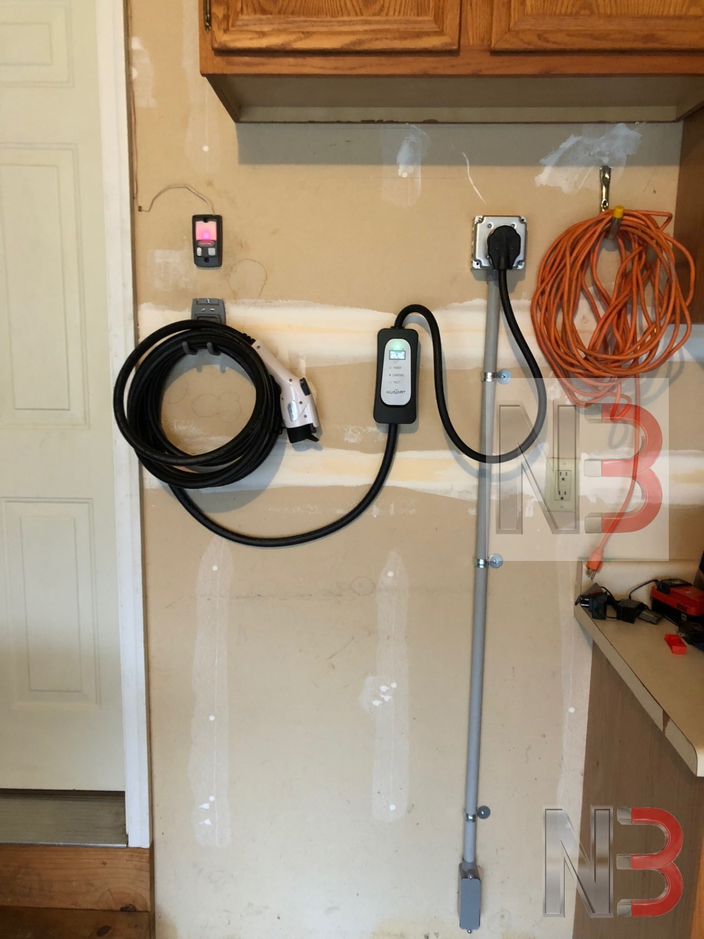 Level 2 EV charger installed in a garage with a new dedicated 240-volt outlet